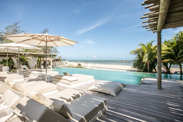 Outdoor pool of Preabeach Boutique Hotel with palm trees and ocean view